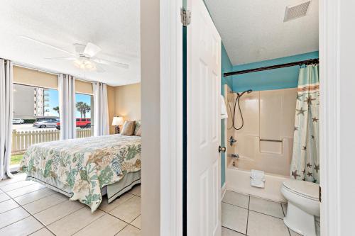 a bedroom with a bed and a bathroom with a tub at Seaside Beach & Racquet 2105 in Orange Beach