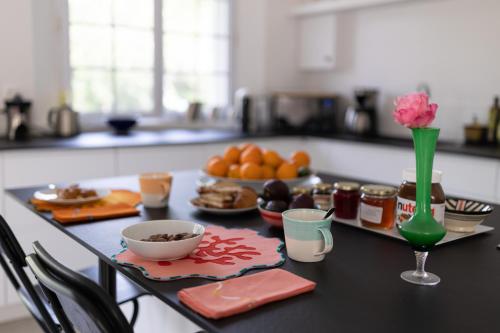 a kitchen counter with a table with food on it at La Métairie - Guesthouse in Orx