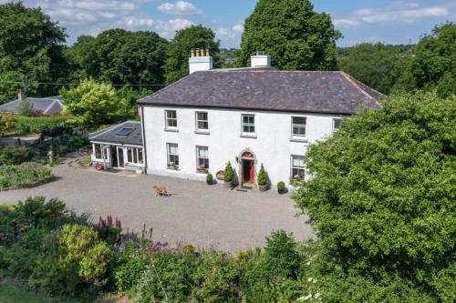 an aerial view of a white house with a yard at The Old Rectory Donard in Dún Ard