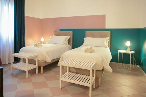 a bedroom with two beds and a blue wall at B&b Apartment 1970 in Lauria Inferiore