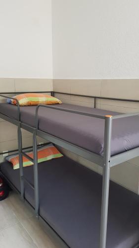 a bunk bed in a room with purple sheets at Studio Apartment Sanja 3 in Neum