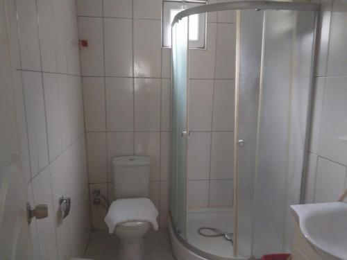 a bathroom with a shower and a toilet and a sink at VİLLAGE GARDEN APART in Kemer