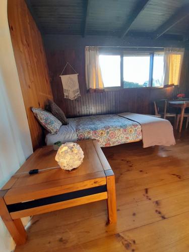 a small bedroom with a bed and a table at Beachouse in Lock Sport