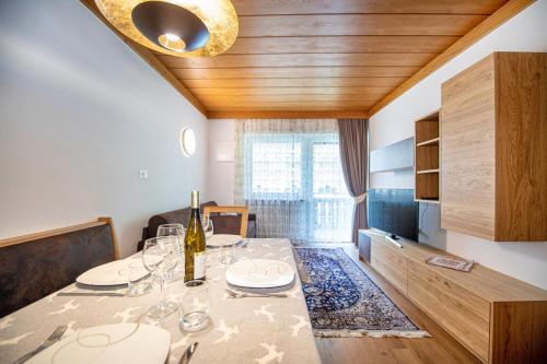 a dining room with a table with wine glasses at Apartment Brunelle in Selva di Val Gardena