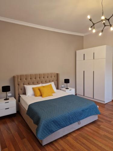 a bedroom with a bed with two night stands and two lamps at SOPRANO APARTMENT KRAKIVSKA 34 in Lviv
