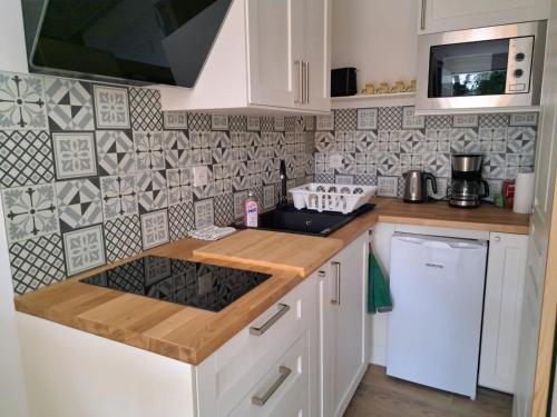 a kitchen with a sink and a stove top oven at La Petite Perle in Andernos-les-Bains