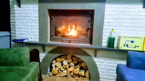a brick fireplace with a fire in it at Villa15 Lodge, Five-Star Stay 5BD 5-5BA Beach Access Villa with Pool , Gym, Sauna, Alfresco Dining & Garden in Manavgat