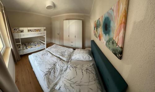 a small bedroom with a bed in a room at Ferienwohnungen WahlHeimat-Pfronten in Pfronten