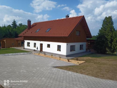 a large white house with a red roof at Chalupa Kozí 62 in Klatovy