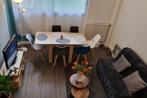 a small living room with a table and a couch at CASITA aux portes de paris in Bagneux