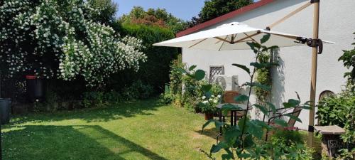a garden with a table and an umbrella at Apartment Lia in Beerfelden