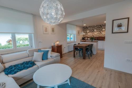 a living room with a couch and a table at APARTMA LAMBERGER in Žirovnica
