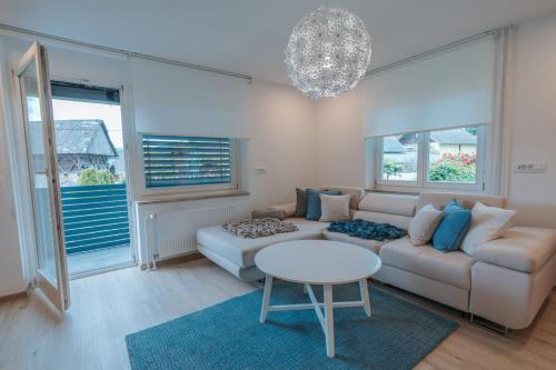 a living room with a couch and a table at APARTMA LAMBERGER in Žirovnica