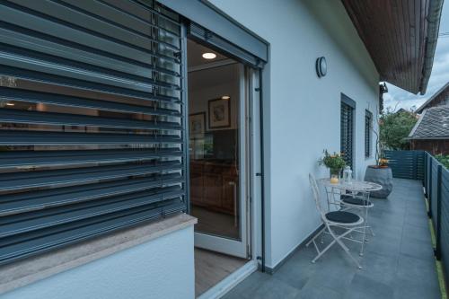 a sliding glass door to a patio with a table at APARTMA LAMBERGER in Žirovnica
