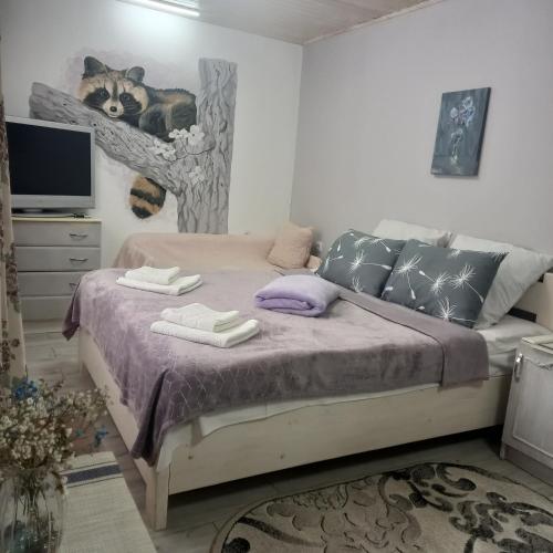 a bedroom with a bed with a cat on the wall at Три горішки in Yaremche
