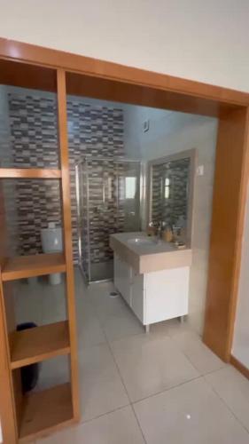 a bathroom with a sink and a mirror at Hellen Apartament in Praia