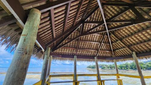 a large straw building with a view of the beach at Ocean Heart Hotel in Sigatoka