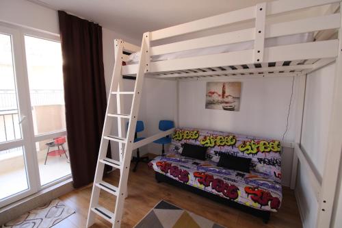 a bedroom with a bunk bed and a ladder at Ipanema Beach - Menada Apartments in Sveti Vlas