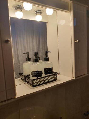 a bathroom sink with a cake in front of a mirror at Villa Magnolia in Litochoro