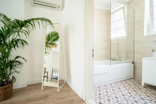 a bathroom with a mirror and a plant at Sandal Alaçatı - Adult Only in Alaçatı