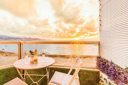 a table and chairs on a balcony with a view of the ocean at El 5º Cielo in Las Palmas de Gran Canaria