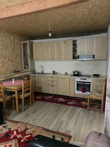 a kitchen with a table and a dining room at Origjina Farm in Përmet