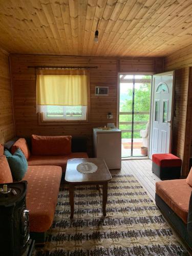a living room with a couch and a table at Origjina Farm in Përmet