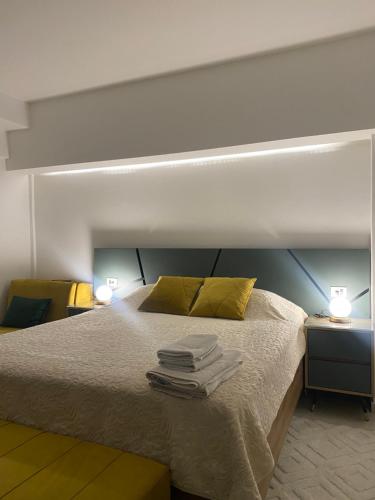 a bedroom with a bed with towels on it at Seafront Apartments in Ulcinj