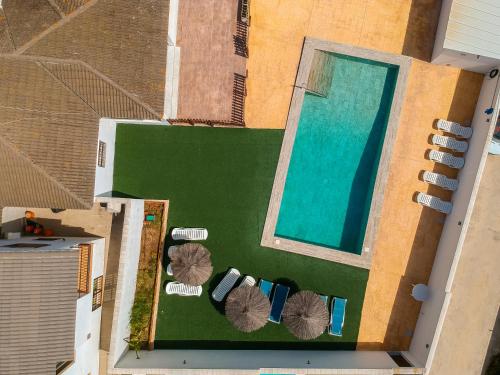 an aerial view of a pool with chairs and a swimming pool at Chalet Privado Rural Barbate in Barbate