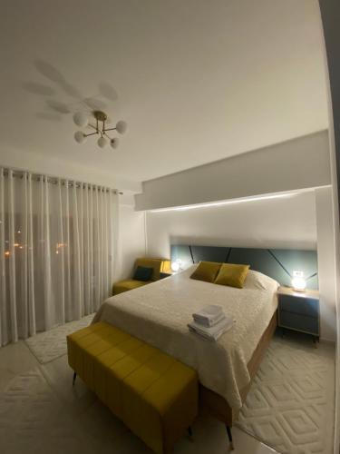 a bedroom with a large bed with yellow pillows at Seafront Apartments in Ulcinj