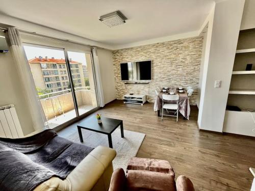 a living room with a couch and a table at appartement paisible face au stade velodrome in Marseille