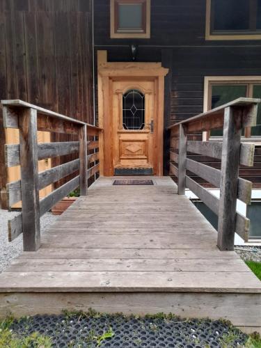 a wooden ramp leading to a wooden door on a house at Stockachhof in Fügenberg