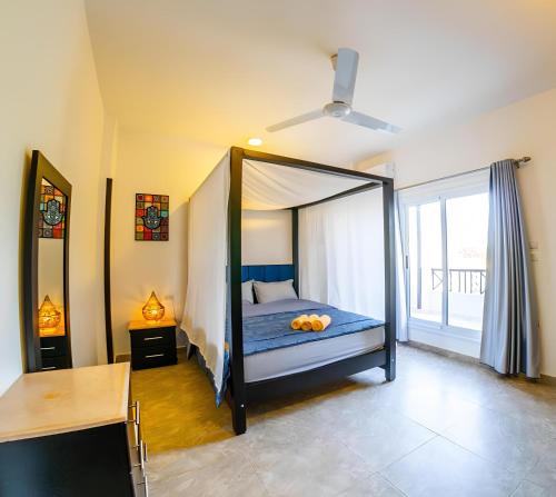 a bedroom with a canopy bed in a room at Royal Home Luxor Nile View in Luxor