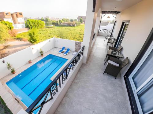 a swimming pool on the balcony of a house at Royal Home Luxor Nile View in Luxor