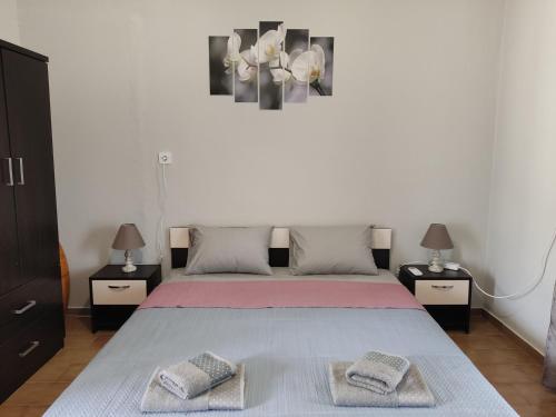 a bedroom with a bed with two towels on it at Elina House and Garden in Nikiti