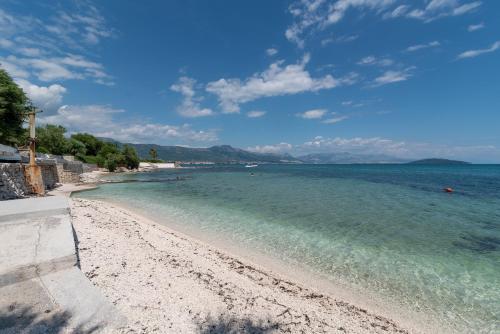 a view of a beach with the ocean at Amazing sea view apartment- Romantica in Kastel Stafilic