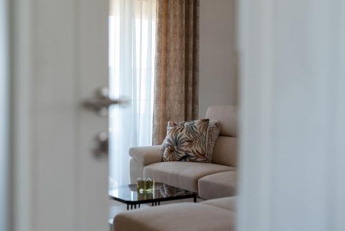 a living room with a chair and a table at Amazing sea view apartment- Romantica in Kastel Stafilic