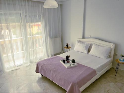 a bedroom with a bed with a tray of food on it at Down town villa Kavala in Kavala