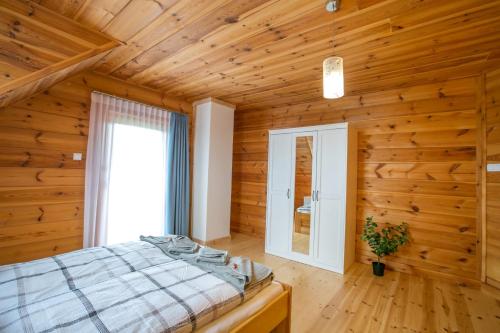 a bedroom with a bed in a wooden room at u Marysi in Polanica-Zdrój