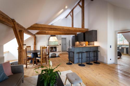 a kitchen and living room with wooden beams at Podenhaus in Bad Aussee