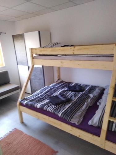 a couple of bunk beds in a room at Apartmány Vihorlat III in Kaluža