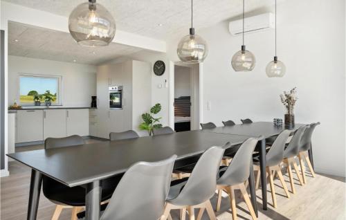 a dining room with a black table and chairs at Pet Friendly Home In Børkop With Wifi in Børkop
