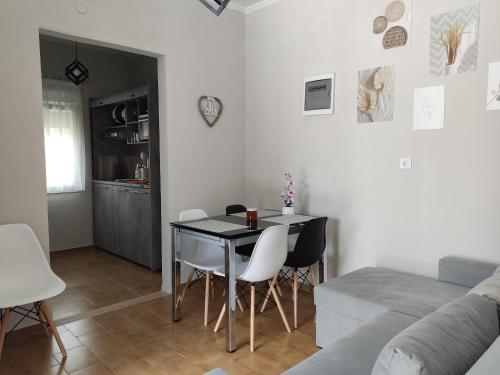 a dining room and living room with a table and chairs at Elina House and Garden in Nikiti