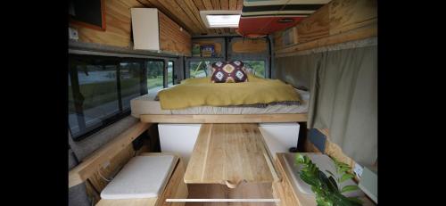 a bed in the inside of a tiny house at Transi the Van in Düsseldorf