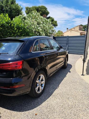 a black car is parked in a driveway at Nimes-Camargues in Garons