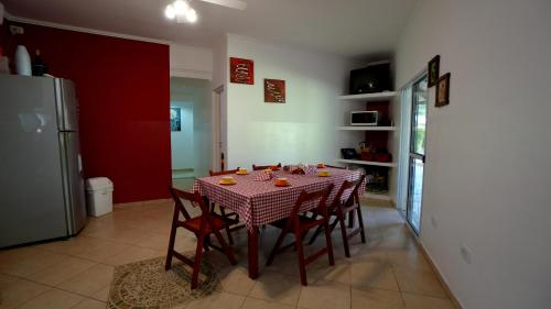 a kitchen with a table with chairs and a refrigerator at ALQUIMIA in Paso de la Patria