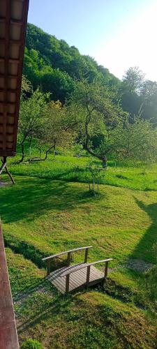 a bench sitting in the middle of a field at Під горою in Sheshory