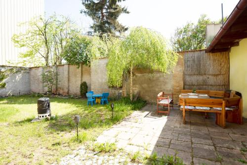 a backyard with a wooden table and chairs at Apartmán Extoll in Třeboň