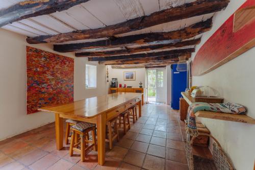 a large kitchen with a wooden table and chairs at Madeira Surf Lodge in São Vicente