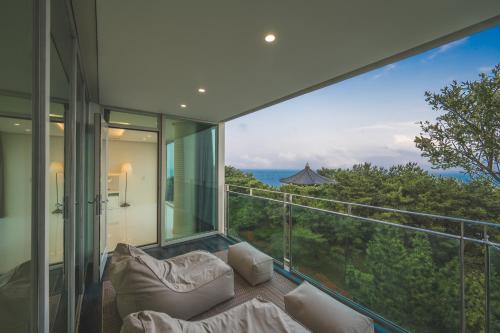 a room with a balcony with a view of the ocean at 500m2 Busan Ocean view private Let house in Busan